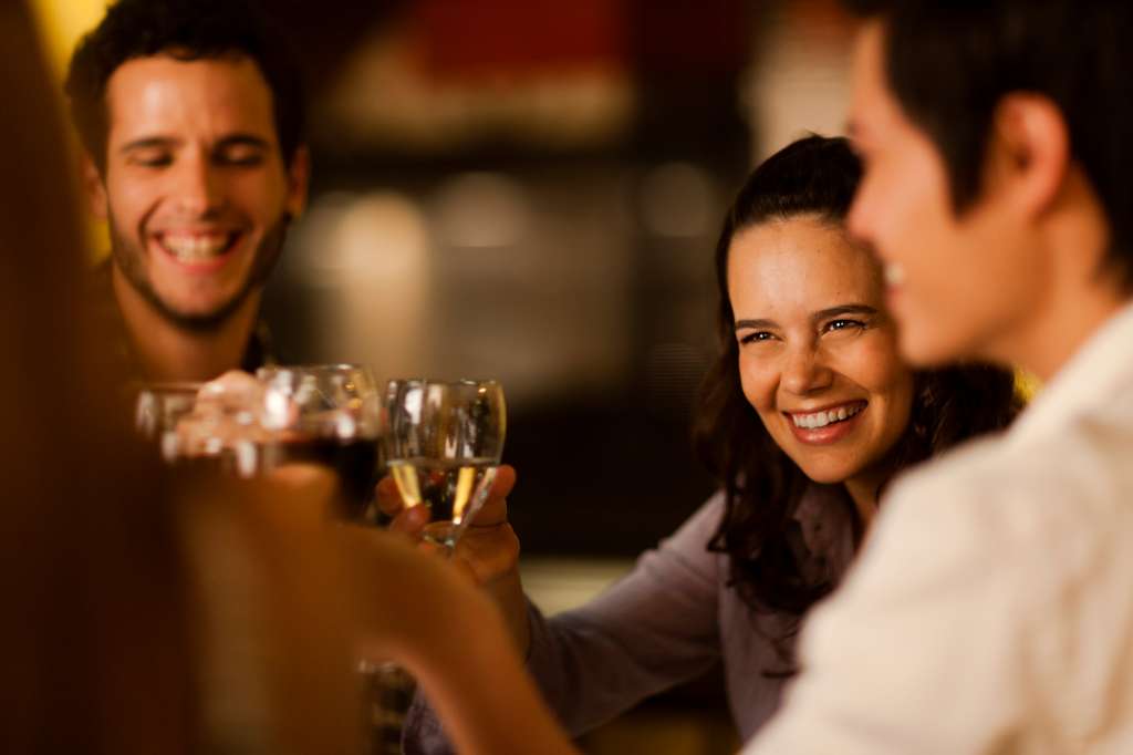 Group of friends toasting with wine