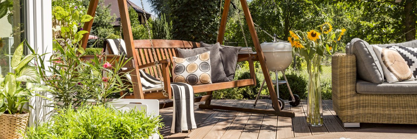 Cozy house terrace with wooden garden swing and a grill ©Ground Pictures