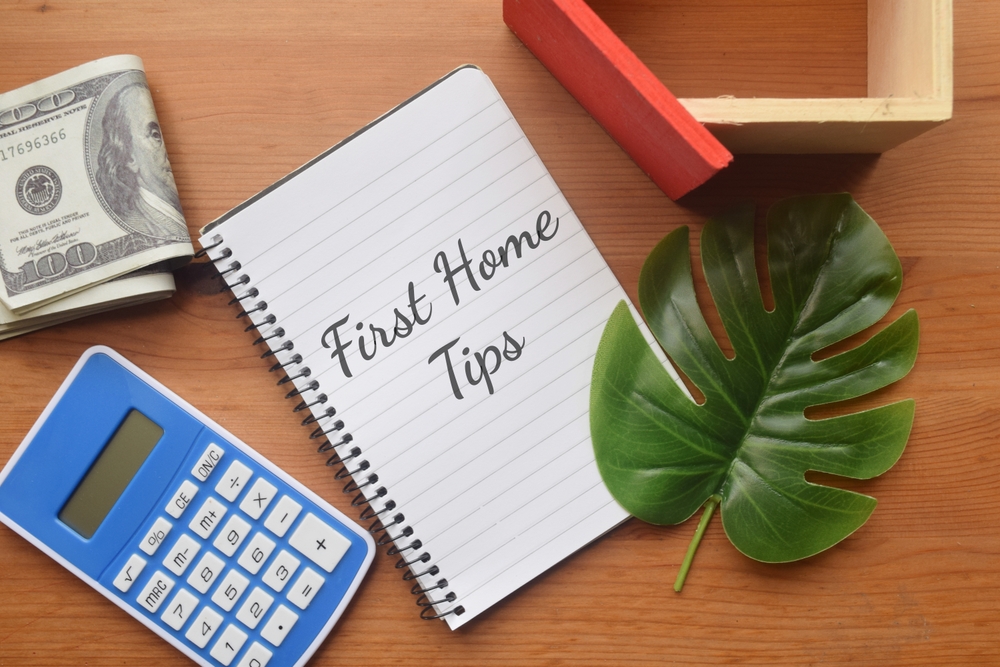First Home Tips wording with calculator, mini house and money. ©FHPhoto
